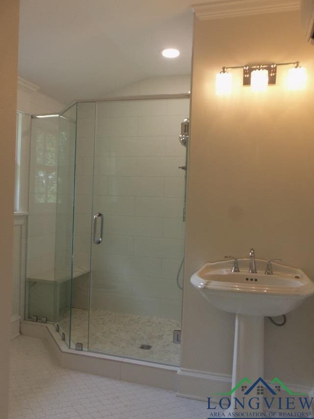 bathroom featuring crown molding, tile patterned flooring, and an enclosed shower