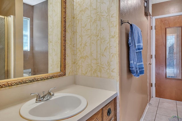 bathroom with tile patterned floors, vanity, and toilet