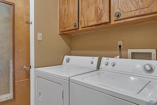 laundry room with cabinet space and washer and clothes dryer