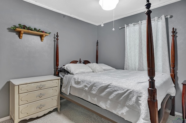 carpeted bedroom featuring baseboards and ornamental molding