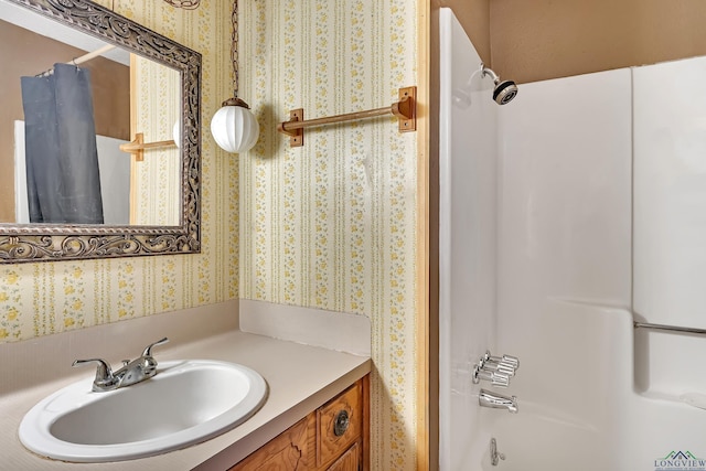full bathroom with shower / bath combination with curtain, vanity, and wallpapered walls