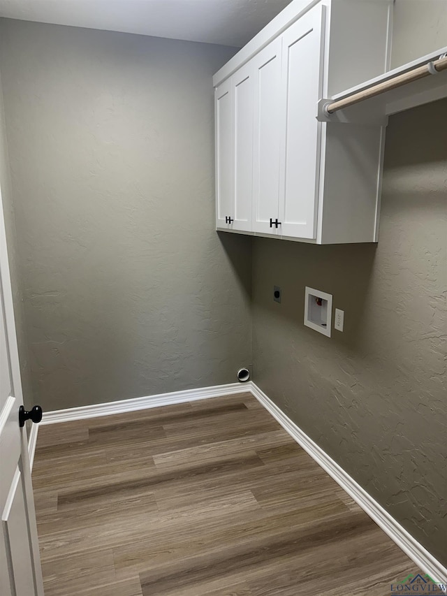 204 Alma St, Longview, TX 75605 - laundry room with electric dryer hookup, wood finished floors, baseboards, washer hookup, and cabinet space