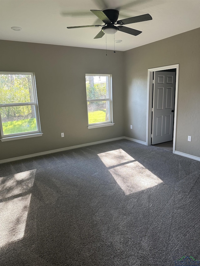 204 Alma St, Longview, TX 75605 - unfurnished room with dark colored carpet, baseboards, and ceiling fan