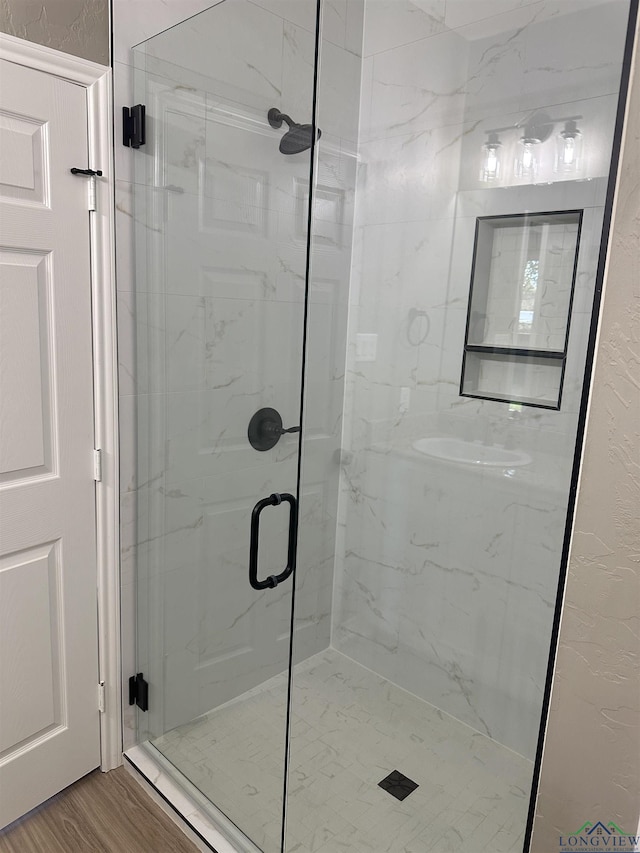 204 Alma St, Longview, TX 75605 - full bathroom featuring a marble finish shower and wood finished floors
