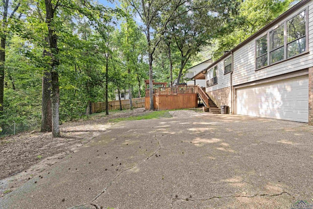 view of yard featuring a deck and a garage