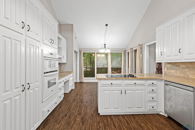 kitchen with dishwasher, kitchen peninsula, hanging light fixtures, vaulted ceiling, and white cabinetry