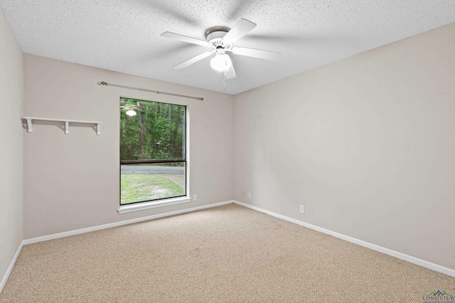 spare room with ceiling fan, carpet floors, and a textured ceiling