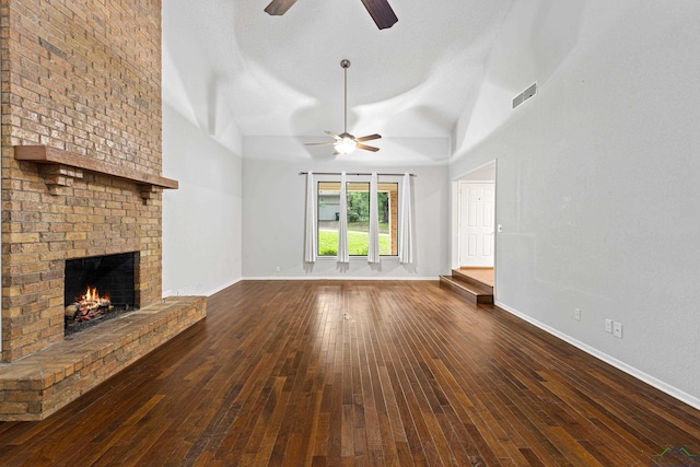 unfurnished living room featuring a fireplace, dark hardwood / wood-style flooring, and lofted ceiling