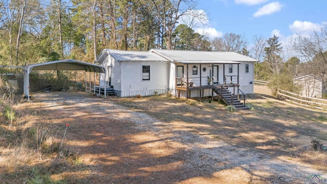 view of front of house with a carport and a porch