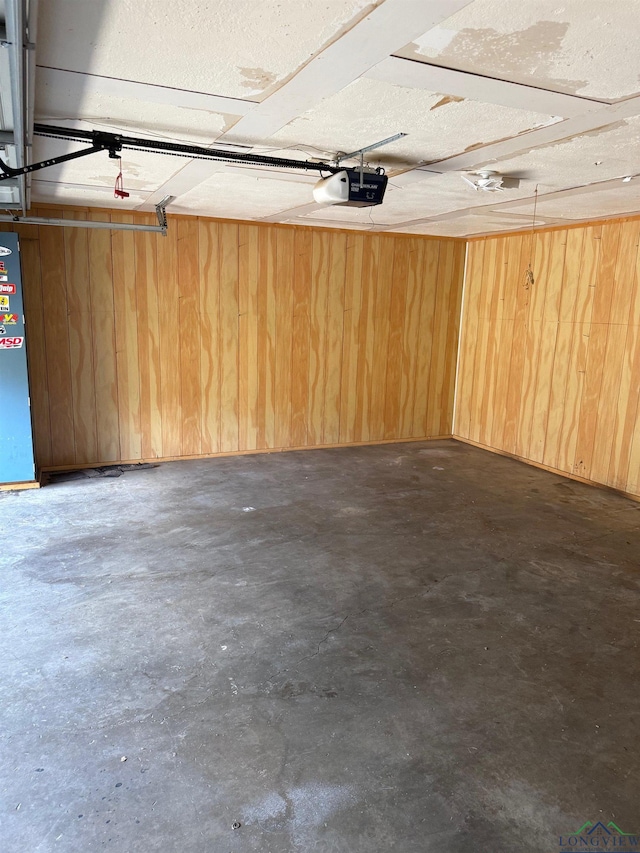 206 Syble Ln, Longview, TX 75605 - garage featuring a garage door opener and wooden walls