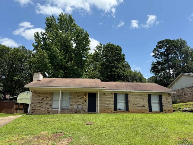 206 Syble Ln, Longview, TX 75605 - ranch-style house featuring brick siding, a front lawn, and a chimney