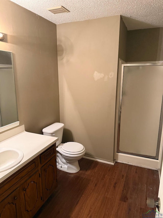 206 Syble Ln, Longview, TX 75605 - bathroom featuring a textured ceiling, a stall shower, vanity, and wood finished floors
