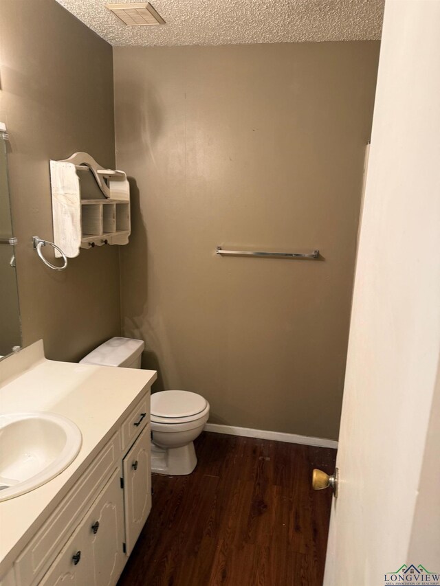 206 Syble Ln, Longview, TX 75605 - bathroom featuring a textured ceiling, vanity, and wood finished floors