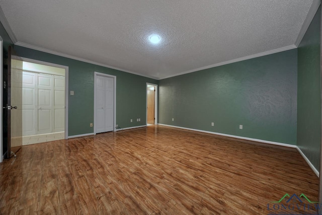 unfurnished bedroom featuring hardwood / wood-style floors, crown molding, and a textured ceiling