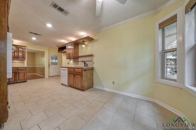 kitchen featuring sink, backsplash, ceiling fan, white dishwasher, and crown molding