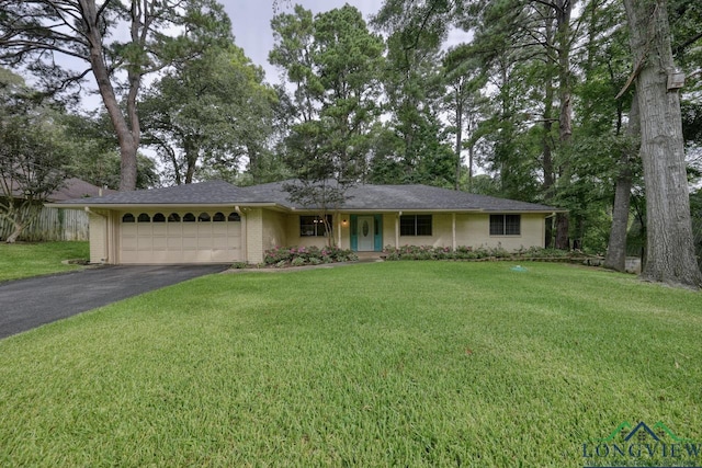 ranch-style home featuring a garage and a front yard