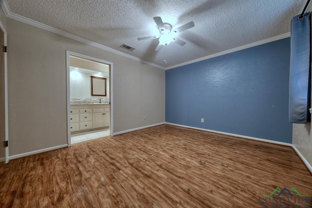 unfurnished bedroom with ornamental molding, connected bathroom, a textured ceiling, and light hardwood / wood-style flooring