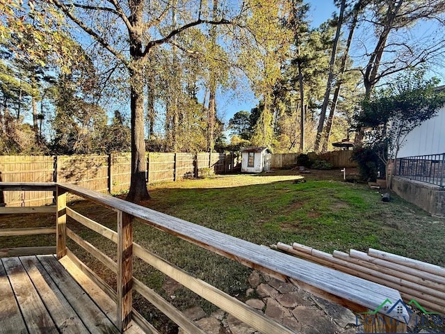 view of yard featuring a storage unit and a wooden deck