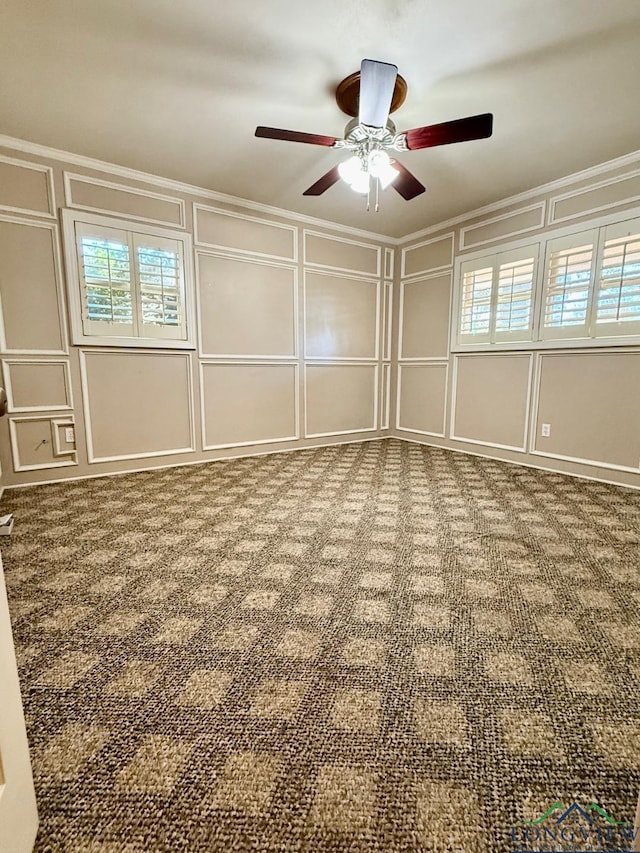 carpeted empty room with ceiling fan and ornamental molding