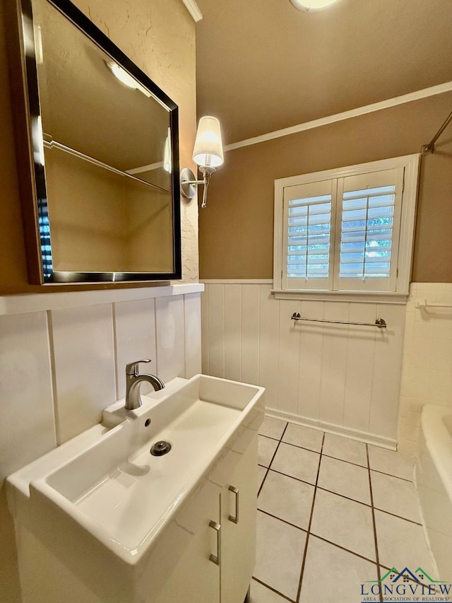 bathroom featuring tile patterned floors, crown molding, and vanity