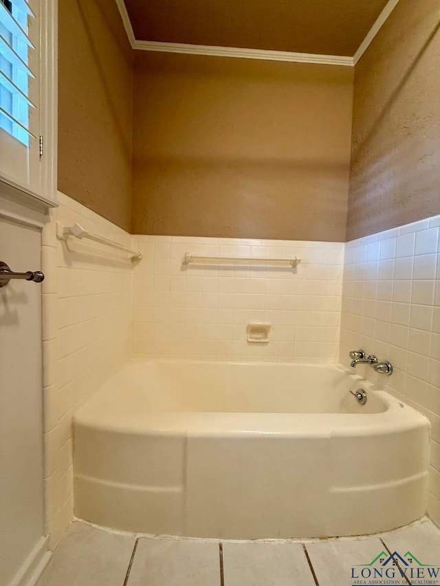 bathroom with tile patterned flooring, a tub to relax in, and tile walls