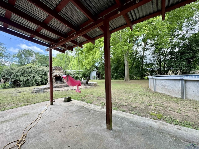1009 Willow Springs Dr, Longview, TX 75604 - view of patio with an outdoor pool and view of wooded area