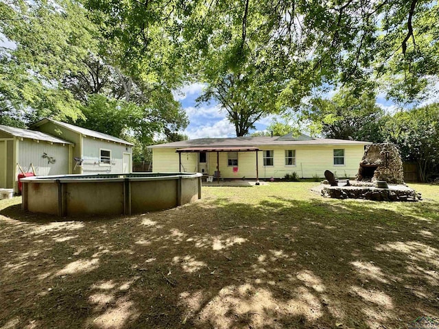 1009 Willow Springs Dr, Longview, TX 75604 - rear view of property featuring an outdoor pool