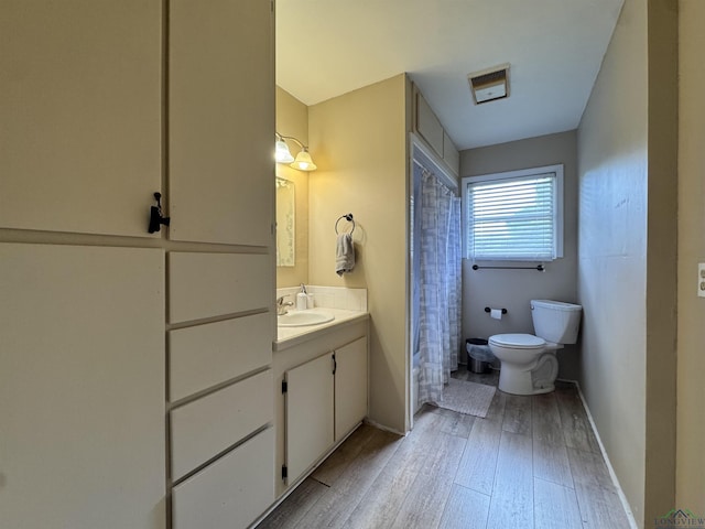 1009 Willow Springs Dr, Longview, TX 75604 - full bathroom featuring vanity, wood-type flooring, and a shower with curtain