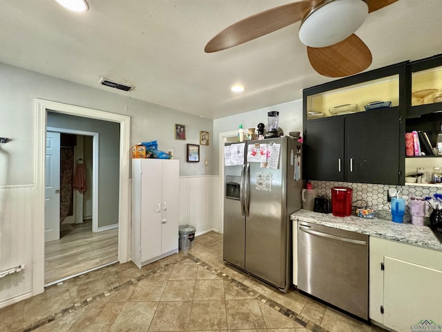 1009 Willow Springs Dr, Longview, TX 75604 - kitchen with appliances with stainless steel finishes, a wainscoted wall, open shelves, recessed lighting, and light tile patterned floors