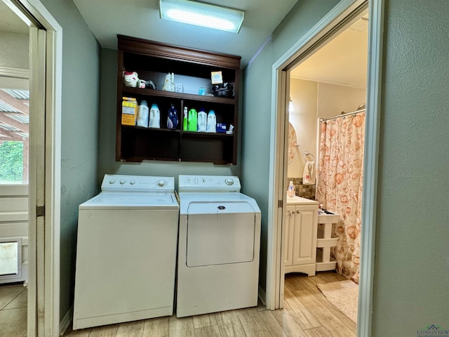 1009 Willow Springs Dr, Longview, TX 75604 - laundry area with washing machine and clothes dryer and light wood-type flooring