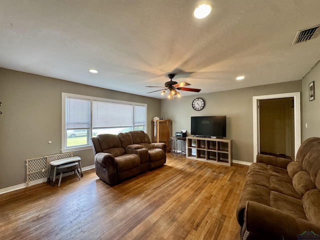 1009 Willow Springs Dr, Longview, TX 75604 - living room with ceiling fan, wood finished floors, recessed lighting, and radiator