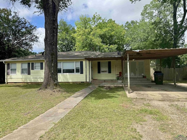 1009 Willow Springs Dr, Longview, TX 75604 - view of front of home with crawl space, a carport, concrete driveway, and french doors
