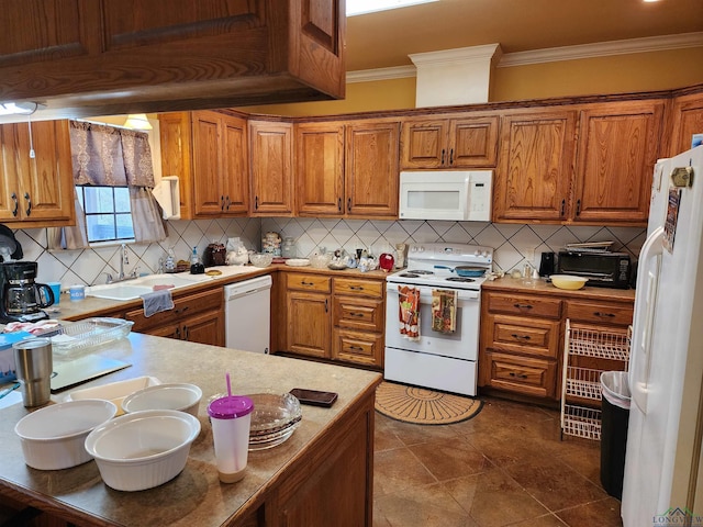 kitchen featuring crown molding, backsplash, white appliances, and kitchen peninsula