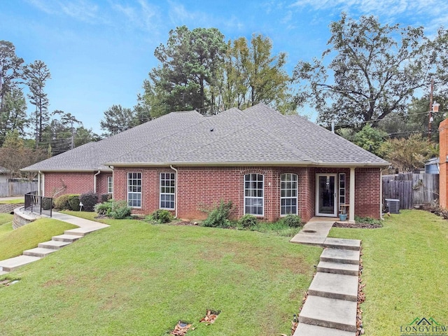 view of front of property featuring a front lawn and central AC unit