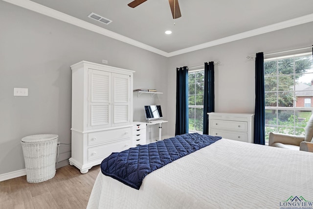 bedroom featuring multiple windows, ceiling fan, light hardwood / wood-style flooring, and crown molding