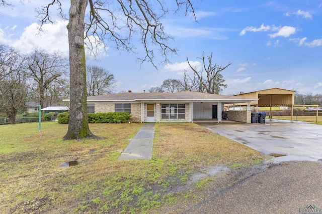 ranch-style home with a front lawn and a carport