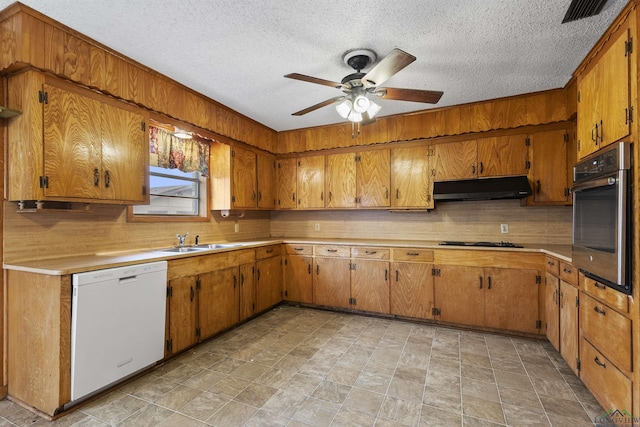 kitchen with sink, dishwasher, decorative backsplash, black gas stovetop, and oven