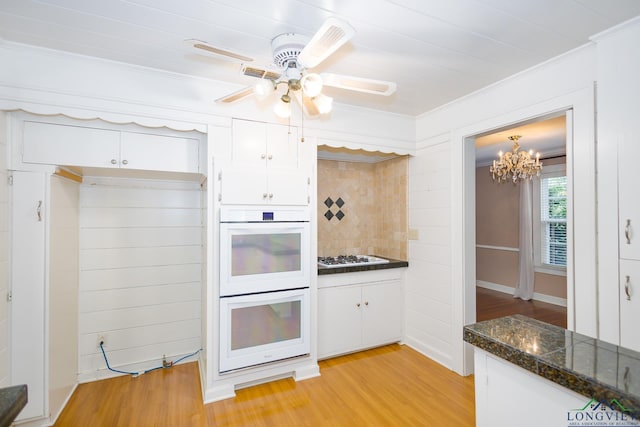 15 Rockwall Dr, Longview, TX 75604 - kitchen featuring double oven, crown molding, white cabinets, light wood-style floors, and decorative backsplash
