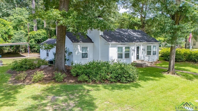15 Rockwall Dr, Longview, TX 75604 - view of front facade featuring a front yard, a shingled roof, and a detached carport