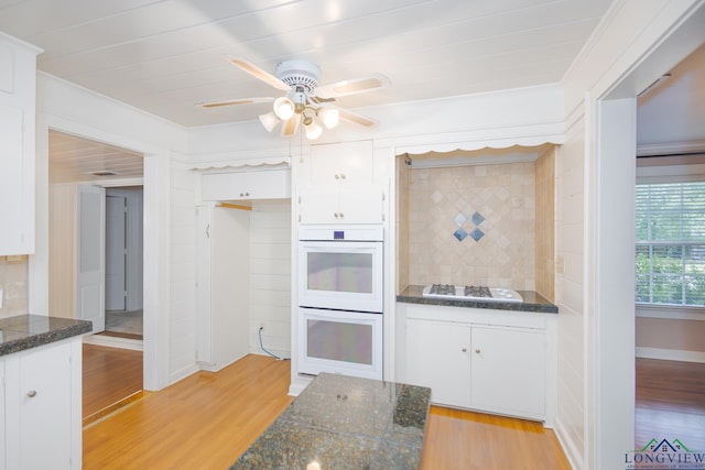 15 Rockwall Dr, Longview, TX 75604 - kitchen featuring gas cooktop, light wood finished floors, white double oven, ornamental molding, and tasteful backsplash