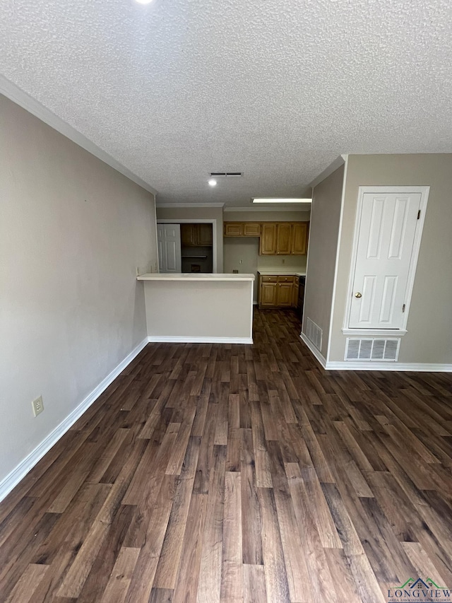 1206 Brandywine Dr, Longview, TX 75601 - unfurnished living room with dark wood-type flooring and a textured ceiling