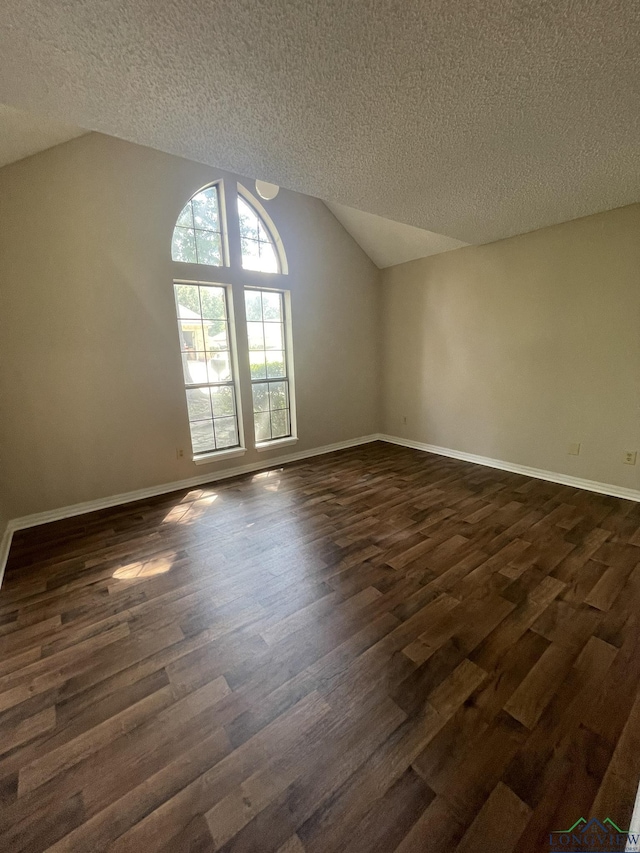1206 Brandywine Dr, Longview, TX 75601 - additional living space featuring a textured ceiling, dark wood-style floors, and vaulted ceiling