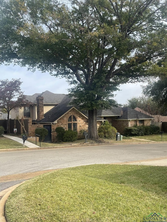 1206 Brandywine Dr, Longview, TX 75601 - view of front facade with a front yard and brick siding