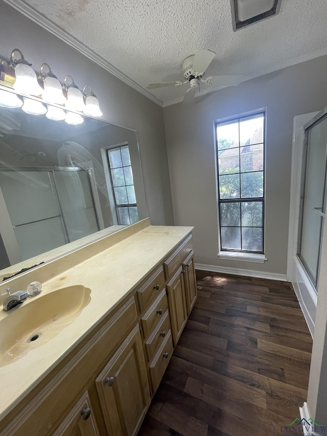 1206 Brandywine Dr, Longview, TX 75601 - full bath with an enclosed shower, wood finished floors, vanity, a textured ceiling, and plenty of natural light