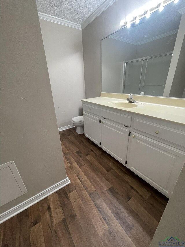 1206 Brandywine Dr, Longview, TX 75601 - full bath with a shower stall, wood finished floors, vanity, ornamental molding, and a textured ceiling