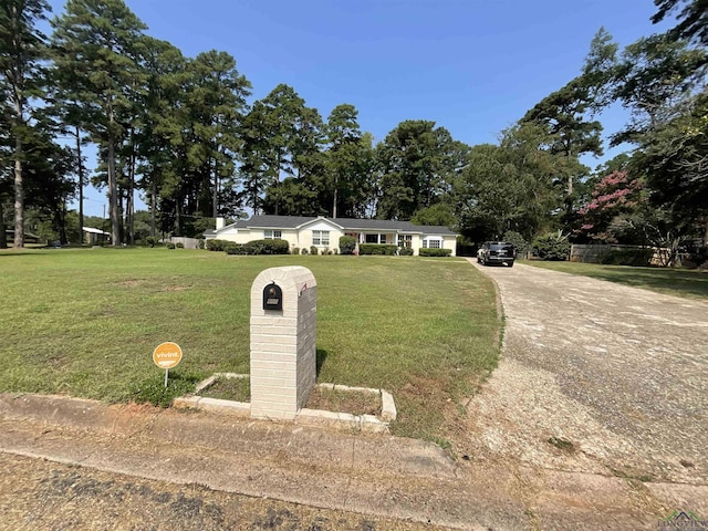 single story home with a front lawn