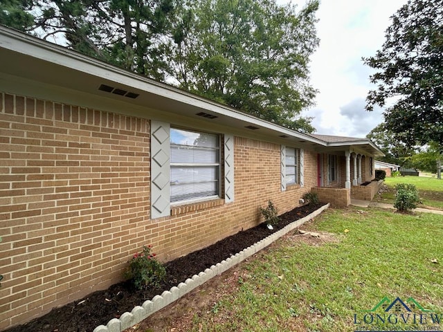 view of side of home featuring a yard