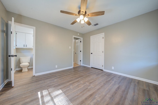 unfurnished bedroom with ceiling fan, connected bathroom, and light hardwood / wood-style flooring