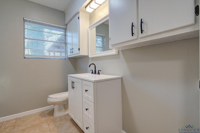 bathroom with tile patterned floors, vanity, and toilet