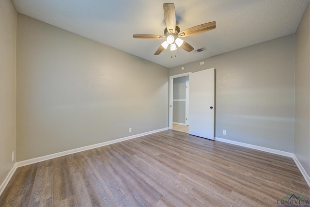 spare room with light hardwood / wood-style floors and ceiling fan